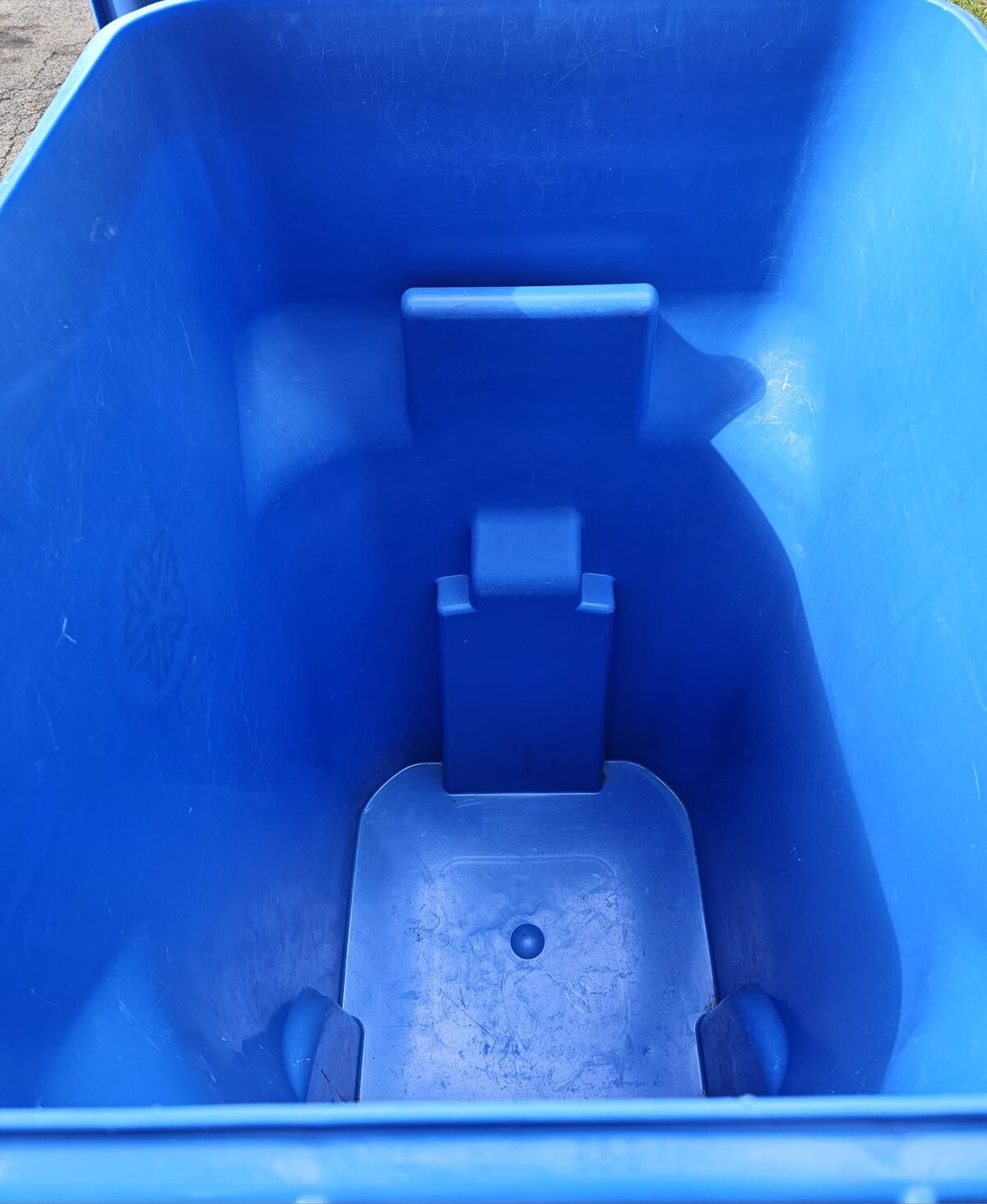 Clean blue recycling bin after professional cleaning
